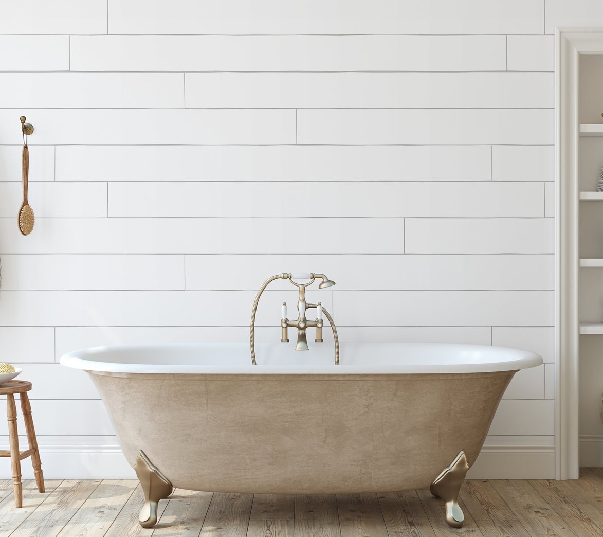 Bathroom with freestanding clawfoot tub and shiplap wall