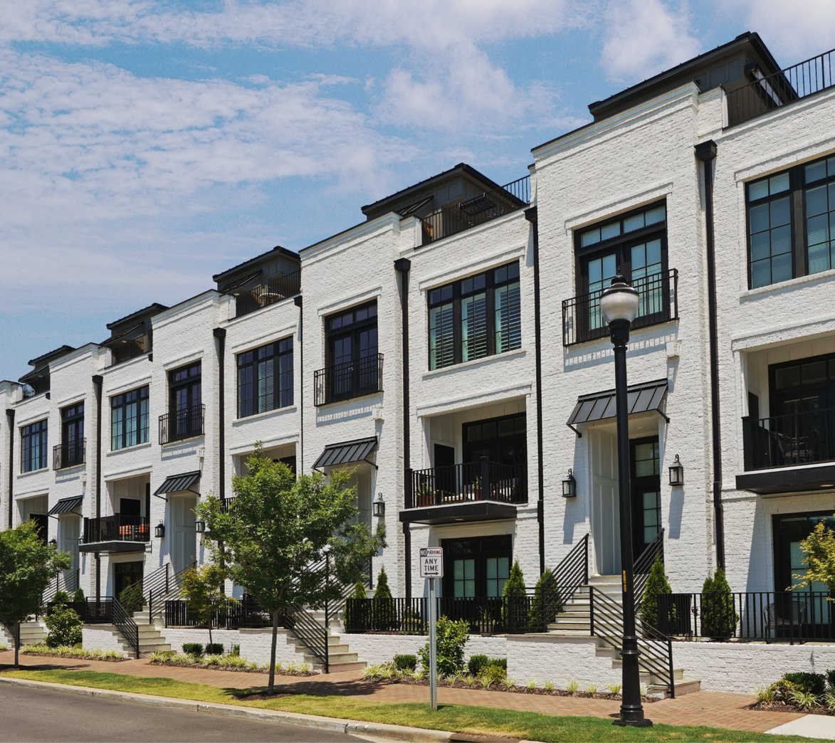 Newly built brick townhomes with black balconies
