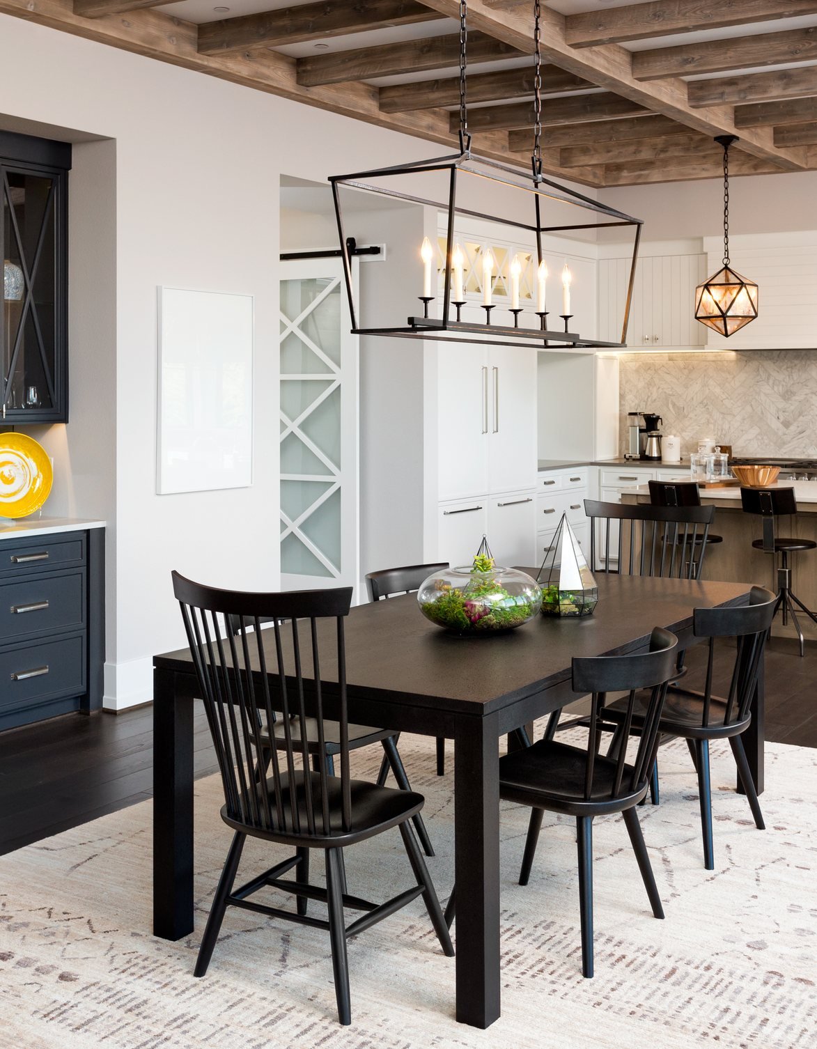 Dining room with timber ceiling beams and iron chandelier