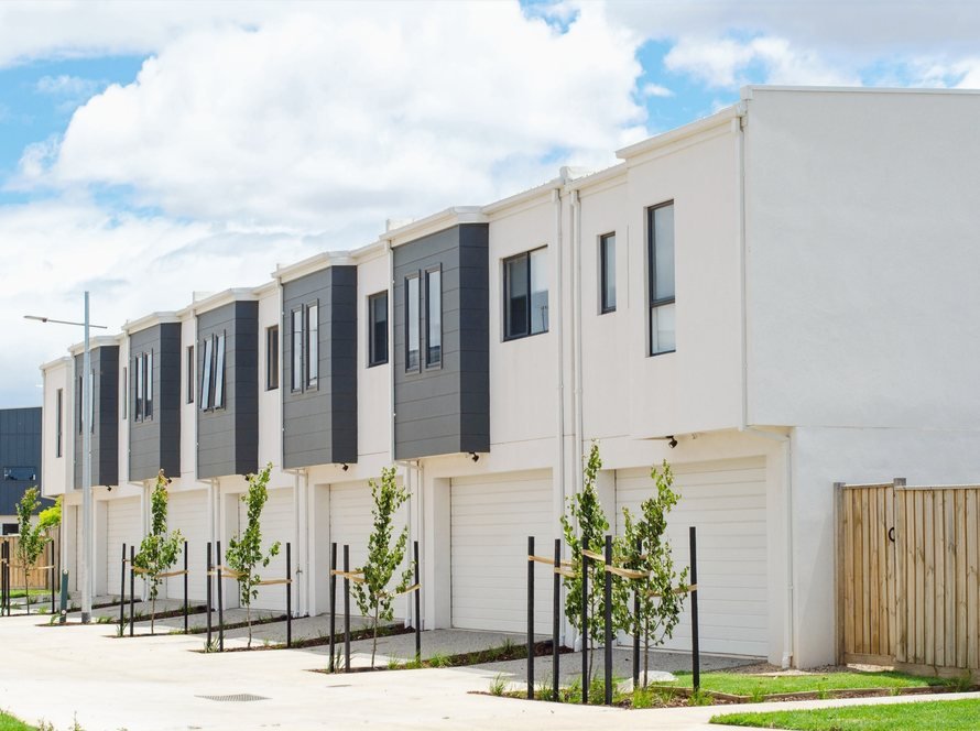 New attached two-story townhomes with young street trees
