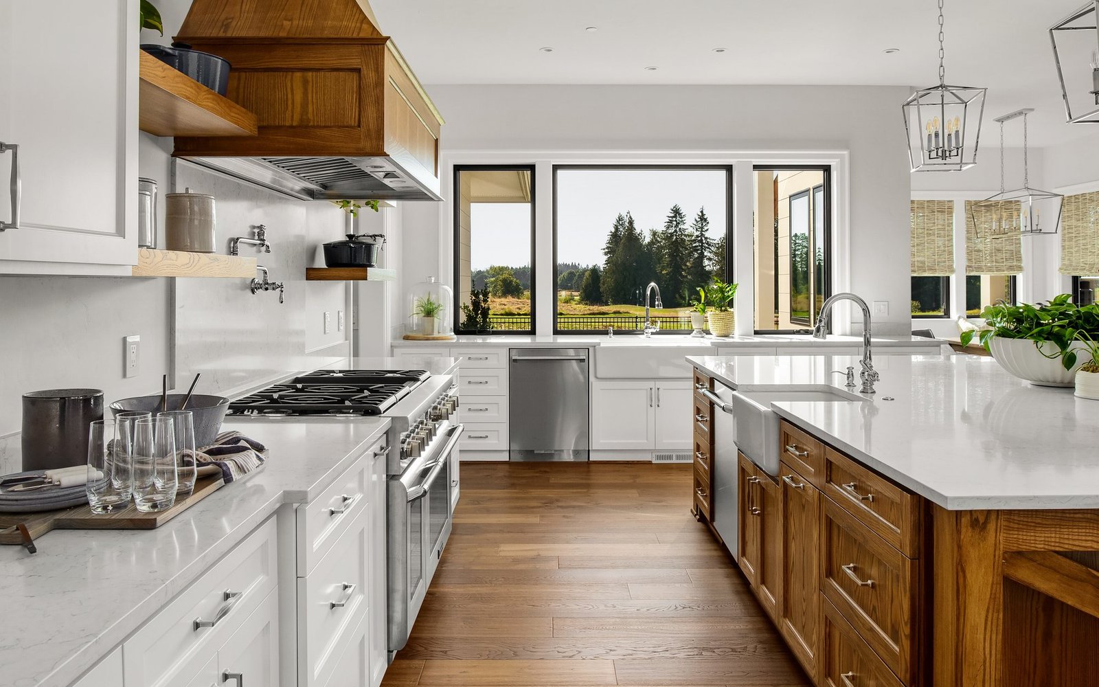 New kitchen with white shaker cabinets, wood-stained island, range hood and wide-plank floors
